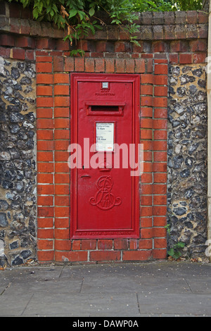 A older type Letter box built into a flint wall in the heart of a town centre. Stock Photo