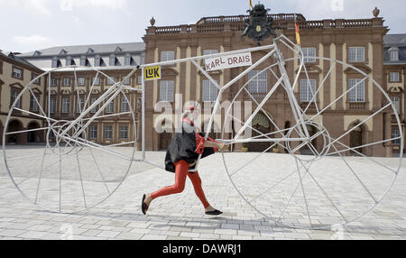 Didi Senft, designer of unusual bicycles pictured in his devil costume riding his velocipede in Mannheim, Germany, 12 June 2007. Senft, aka the crazy devil from the Tour de France, invented and built the 2.86 metres tall velocipede to be listed in the Guinnes World Records book. Photo: Ronald Wittek Stock Photo