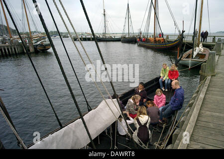 Visitors sit in a reconstructed Viking ship that lies in the harbour of the museum for Viking ships in Roskilde, Denmark, 22 May 2007. Shipbuilding and seafaring of the Vikings are presented in the museum that has its own wharf and an archaeological workshop and offers Viking ship boat trips in the summer. Photo: Maurizio Gambarini