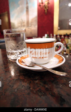 A glass of water and a typical espresso pictured at Antico Caffe Greco in Rome, Italy, 25 April 2007. The coffeehouse was opened in 1760 by Nicola Della Maddalena and had among its regulars many thinkers, artists and writers - Goethe, Wagner, Mendelssohn, Stendhal and Liszt being the most famous ones. Photo: Lars Halbauer Stock Photo