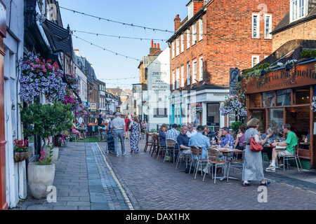 The road is closed and tables are set out for alfresco dining in summer in Church street, Twickenham, UK Stock Photo