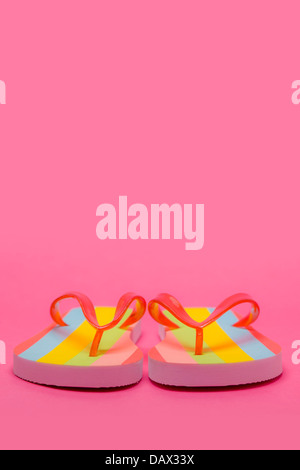 Pair of Flip flops on pink background Stock Photo