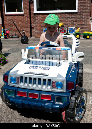 Young two year old boy in radio controlled car, England, UK. Stock Photo