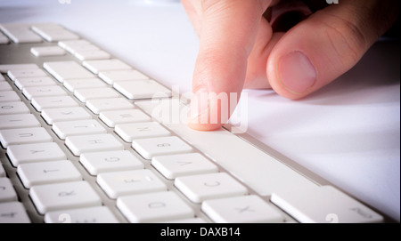 Selective focus on the male finger on space button Stock Photo