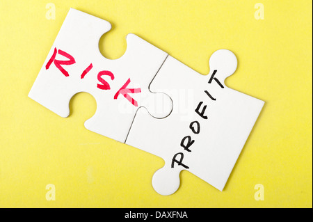 Risk and profit words written on two pieces of puzzle Stock Photo