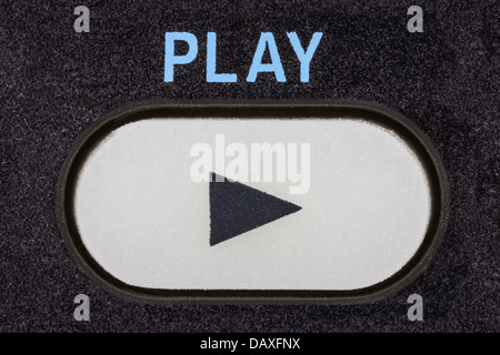 Remote control device play button macro detail. Stock Photo