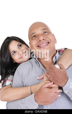 Thoughtful couple hugging and looking up - isolated over white. Focus in the woman Stock Photo