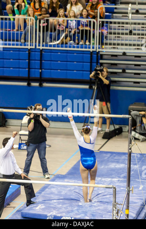 Woman competes for UF on uneven parallel bars during Alabama Crimson Tide versus UF Gators Women's Gymnastics Meet (2-8-13). Stock Photo