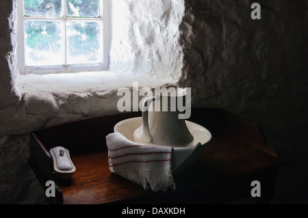 Old fashioned wash jug and basin by the window of a traditional Irish farmhouse Stock Photo