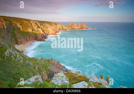 Logan Rock and Pednvouder Beach from Treen Cliff near to Porthcurno in Cornwall, England, UK Stock Photo