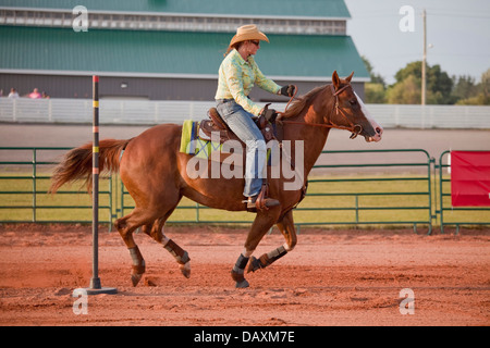 Lady competing in a barrel race at an indoor arena at Tamworth ...