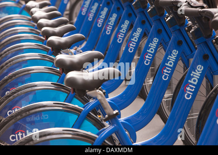 Public bicycles of the Citi Bike NYC bike sharing program wait in their docking stations for the next riders. Stock Photo