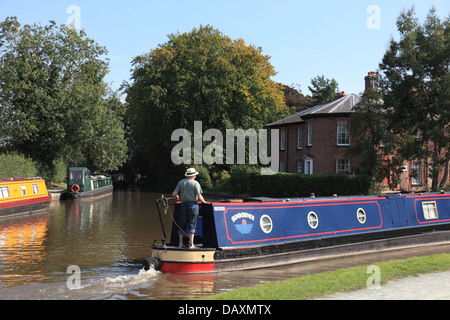 A narrowboat on the Llangollen Canal at Ellesmere with the canal company building designed by Thomas Telford in the background Stock Photo