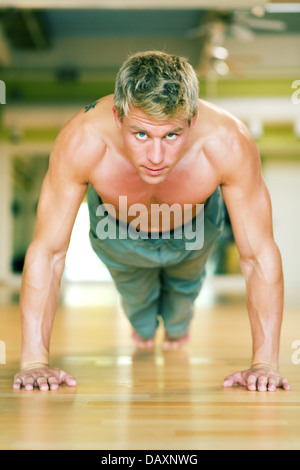 Young handsome man doing push ups outdoors Stock Photo - Alamy