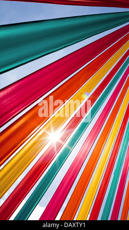 Sunlight flares through richly coloured ribbons. Stock Photo