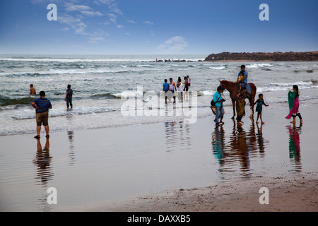 Tourists enjoying on the beach, Rishikonda Beach, Vishakhapatnam, Andhra Pradesh, India Stock Photo