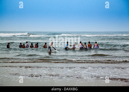 Tourists enjoying on the beach, Rishikonda Beach, Vishakhapatnam, Andhra Pradesh, India Stock Photo