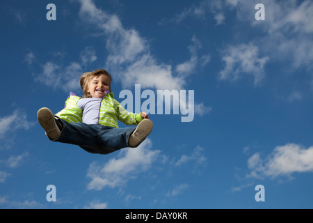 Two years old girl flying in the sky Stock Photo