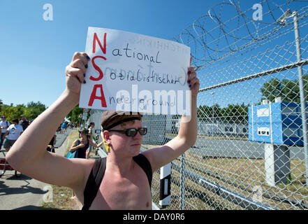 Berlin, Germany. 20th July, 2013.  A few hundred people take part in a protest outside of a US National Security Agency (NSA) listening station in Griesheim near Darmstadt, Germany, 20 July 2013. As part of the 'Picknick' action, participents assembled outside of the strictly restricted US Army 'Dagger Complex' temporarily blocking the street. Photo: BORIS ROESSLER/dpa/Alamy Live News Credit:  dpa picture alliance/Alamy Live News Stock Photo