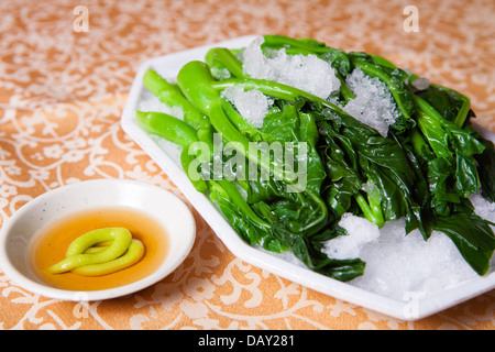 salad of spinach and mustard on white plates Stock Photo