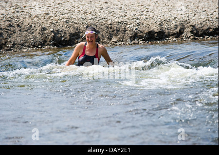 As temperatures reach 30ºC young woman cooling off in the River Wye at The Warren Hay on Wye, Powys, Wales, UK Stock Photo