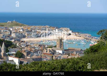 Looking down on St. Ives Cornish seaside town buildings, harbour boats, beach and sea.  Cornwall England. Stock Photo