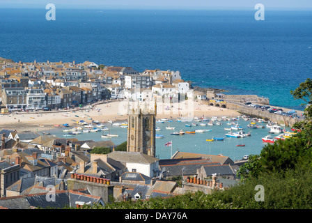 Looking down on St. Ives Cornish seaside town buildings, harbour boats, beach and sea.  Cornwall England. Stock Photo