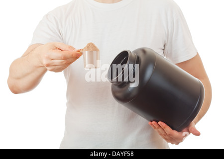 Man's  holding scoop of  chocolate whey protein shake Stock Photo