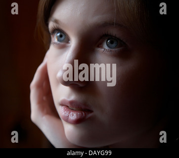Portrait of the girl in a dark tonality on a dark background Stock Photo