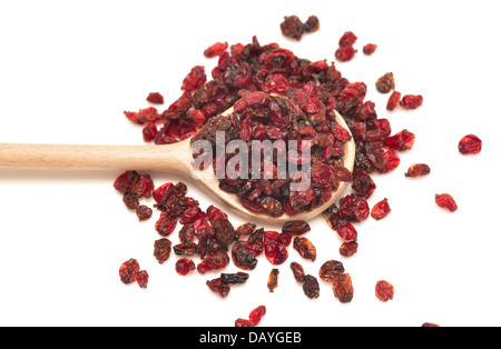 dried barberry in a wooden spoon isolated on white Stock Photo