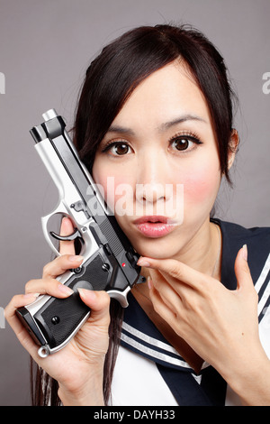 School girl plays gun. Stock Photo