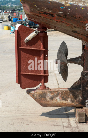 Rudder and propeller on UK fishing boat showing sacrificial anode attached to rudder Stock Photo