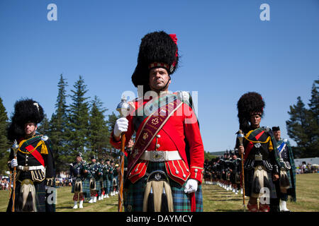 Scottish marching band at Tomintoul, UK. July, 2013. The Drum Major of Ballater Pipe band at the annual Tomintoul Highland games and gathering held on the 3rd Saturday in July, at the showground in the village.  This sporting, historical and traditional event in the previous years, has been beset with bad weather and has been cancelled on several occasions. The Cairngorms National Park is home to some of the best and most famous Highland Games in Scotland and has a long tradition and history where Clans would compete against each other in sporting events. Stock Photo