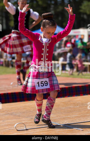 Tomintoul, UK. 20th July, 2013. Traditional Highland reel dancers at the annual Tomintoul Scottish games and gathering held on the 3rd Saturday in July, at the showground in the village.  This highland village, hosts a sporting, historical and traditional event during July, in the Cairngorms National Park; One of the best and most famous Highland Games in Scotland. Highland gatherings have a long tradition and history when rival Clans competitors, musicians and dancers, who were important for the prestige of the clan chieftain's, would compete against each other in sporting events. Stock Photo