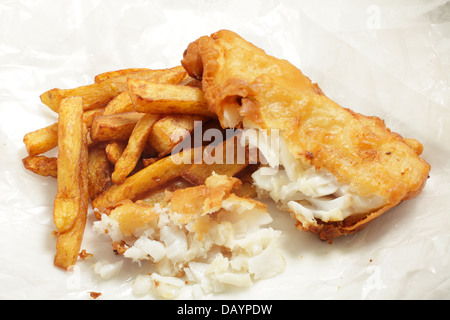 British 'chip shop' style fried cod in batter with chips (french fries) in a wrapping of greaseproof paper. Stock Photo