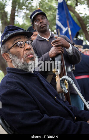 Civil War re-enactors representing the all black 54th Massachusetts Volunteer Infantry listen during a ceremony unveiling a memorial honoring the 54th on the 150th anniversary of the assault on Battery Wagner July 21, 2013 in Charleston, SC. The battle memorialized in the movie 'Glory' took place in Charleston and was the first major battle of an all black regiment. Stock Photo