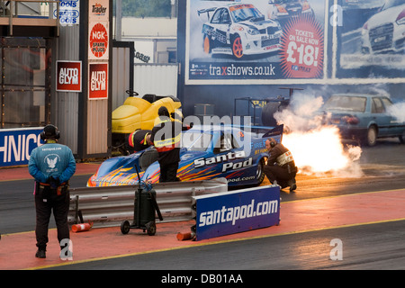 Santa Pod Jet Funny Car Fire Force at the warm up to setting it off with pit crew in attendance Stock Photo