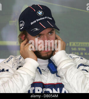 German Formula One pilot Nick Heidfeld of BMW Sauber holds his ears at the pitlane of Nevers Magny-Cours Circuit near Nevers, France, 29 June 2007. The Formula One Grand Prix of France 2007 will be held on 01 July. Photo: Carmen Jaspersen Stock Photo