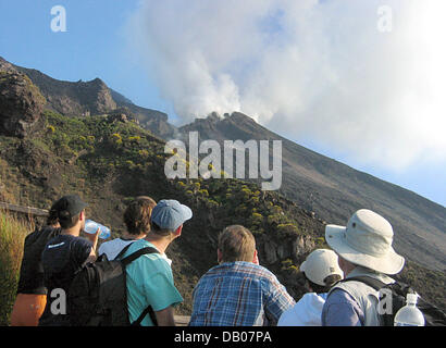 Tourists watch the plume of the active volcano Stromboli on the Aeolian island of the same name in Italy, 30 May 2007. The Aeolian Islands  with the main island of Liparei and Salina are a volcanic archipelago offshore northern Sicily. The islands consist of ashes and lava of mostly extinct volcanos. The archipleago belonging to the Province Messina is situated in an earthquake ris Stock Photo