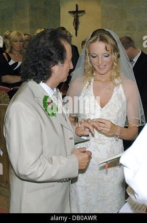 Singer Chris Andrews and his newly-wedded wife Alexandra Andrews exchange rings during their church marriage in Luenen near Dortmund, Germany, 29 July 2007. dpa Stock Photo