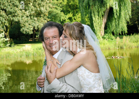 Singer Chris Andrews and his newly-wedded wife Alexandra Andrews pose shortly after their church marriage in Luenen near Dortmund, Germany, 29 July 2007. dpa Stock Photo