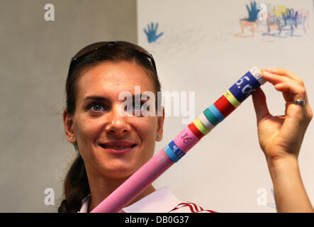 Russian pole vaulter Yelena Isinbayeva poses with a pole marking 5.01 meters during a spnonsor's photo call prior to the 11th 'IAAF World Championships in Athletics' in Osaka, Japan, 24 August 2007. Olympic champion and world record holder Isinbayeva is fancied at the championships, beginning Saturday, 25 August. Photo: Gero Breloer Stock Photo