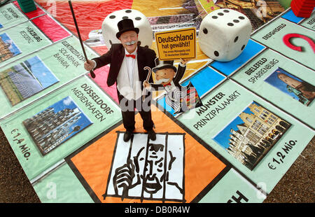 'Mister Monopoly' poses on an oversized version of the new 'German cities Monopoly' board featuring 22 German cities in Saarbruecken, Germany, 18 September 2007. An internet vote had decided on which cities were to be represented on the board. Saarbruecken achieved the highest number of alltogether 550,000 votes and will be the most expensive address on the board, replacing 'Boardw