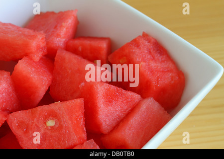 Watermelon cubes in white bowl, close up Stock Photo