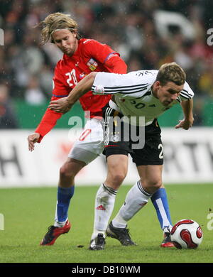 German national team player Lukas Podolski (R) vies for the ball with the Czech goalscorer Jaroslav Plasil (L) during the Euro2008 qualifying match Germany vs Czech Republic at Allianz Arena in Munich, Germany, 17 October 2007. Germany was defeated 0-3. Photo: Bernd Weissbrod Stock Photo