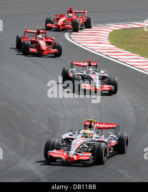 British Formula One rookie Lewis Hamilton of McLaren Mercedes heads Spanish team-mate Fernando Alonso, Finnish Kimi Raikkonen of Scuderia Ferrari and his Brazilian team-mate Felipe Massa during the Q3 Qualifying session to the Formula 1 Grand Prix of Brazil at Carlos Pace race circuit in Interlagos near Sao Paulo, Brazil, 20 October 2007. Hamilton could become the first-ever rookie Stock Photo