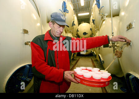 FILE - An employee taps a beer from tanks in which the taste and smell of the beer are refined in the 'Budweiser Budvar' brewery in Ceske Budejovice, Czech Republic, 12 December 2007. The beer can already be tasted at this point of the production. Nearly the half of the production is exported to more than 50 countries worldwide. Photo: Bjoern Steinz Stock Photo