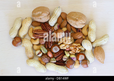Nut mix with and without shell on wooden surface Stock Photo
