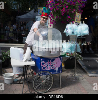 Calgary, Alberta. 21st July, 2013. Man makes cotton candy at the Sun and Salsa festival in the Kensington area of Calgary, Alberta, Canada on Sunday, July 21, 2013. This annual event raises funds for charity and showcases local businesses. Credit:  Rosanne Tackaberry/Alamy Live News Stock Photo