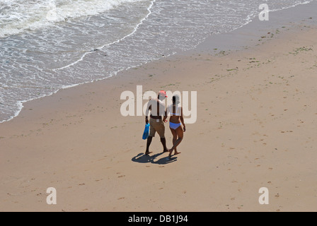 Broadstairs, Kent, England, UK. Young couple walking hand-in-hand on the beach Stock Photo
